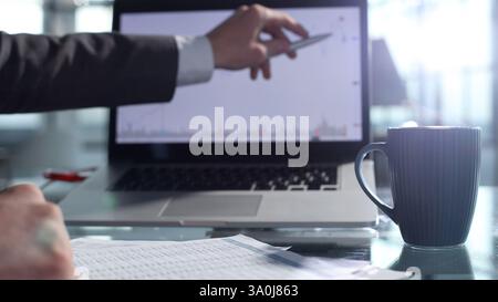 Checking charts on the Internet and documentation Stock Photo