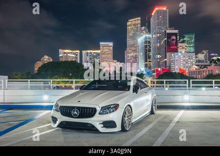 A white colored Mercedes AMG E 53 sports car in downtown Miami, Florida, USA at night. Stock Photo