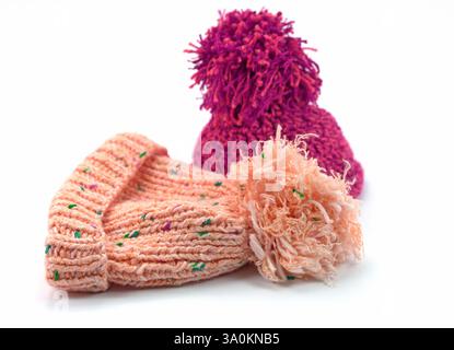 Two bobble hats against a white background Stock Photo