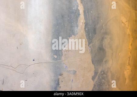 Textured surface featuring an abstract interplay of beige, blue, and gray colors with cracks and natural fissures, conveying a rustic and artistic amb Stock Photo