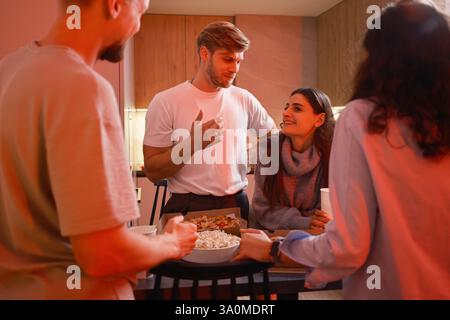 Group of friends having a casual gathering enjoying snacks and conversation Stock Photo