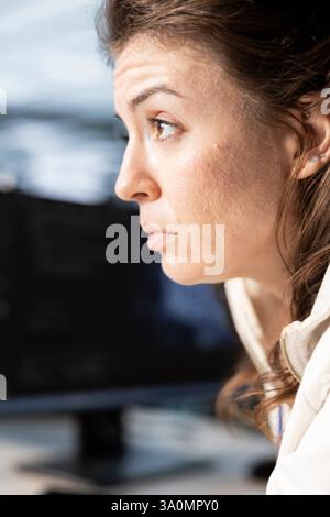 Technician in data center workplace coordinating deployment of server architecture, improving data processing speed. Worker in server farm configuring and testing equipment, close up Stock Photo