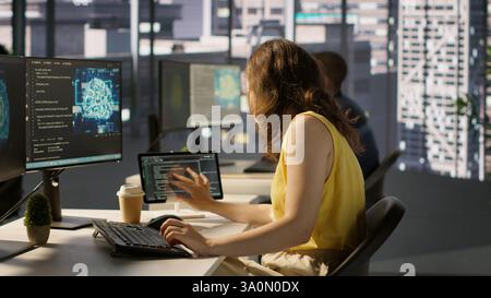 Admin developing artificial intelligence machine learning APIs solving complex problems. Woman training AI predictive models capable of handling resource intensive tasks, camera A Stock Photo