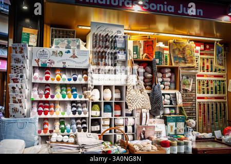 VALENCIA, SPAIN - OCTOBER 13, 2024: A display of yarn, threads, and crochet tools inside a merceria (mercery) in Valencia. Various crafting accessorie Stock Photo