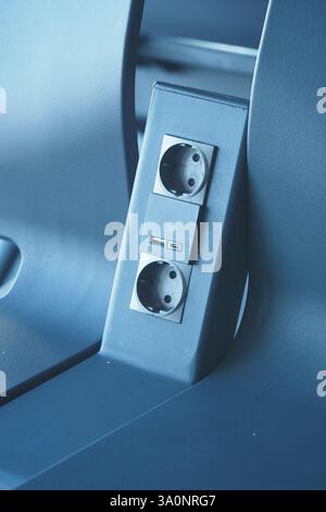 Charging station with power outlets and USB port in a modern car Stock Photo