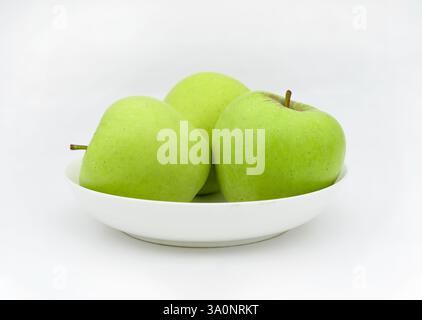 A plate of green apples on white background Stock Photo