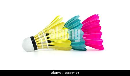 Close-up of three brightly colored badminton shuttlecocks arranged in a row on a white surface, perfect for sports or recreational concepts. Stock Photo