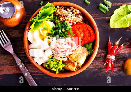 Delicious healthy breakfasts, buckwheat with boiled egg and meat and cheese Stock Photo