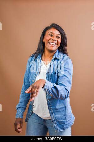 Studio portrait of a cheerful african american woman laughing and enjoying herself Stock Photo
