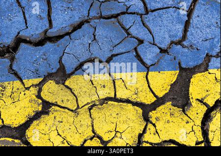 Cracked Ukraine flag. Ukrainian flag painted on a cracked wall. Distressed flag of Ukraine with cracks Stock Photo