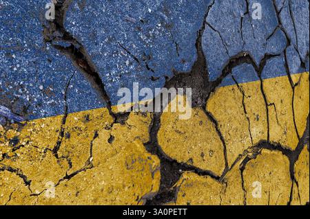 Cracked Ukraine flag. Ukrainian flag painted on a cracked wall. Distressed flag of Ukraine with cracks Stock Photo