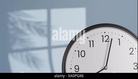 Image of fast moving hands on clock over wall with shadow of leaves and window Stock Photo