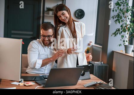 Two employees are working together in the modern office. Stock Photo