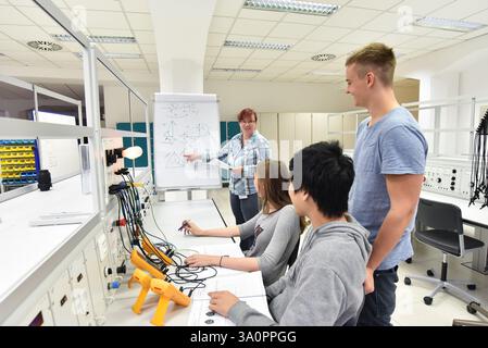 Group of young people in technical vocational training with teacher Stock Photo