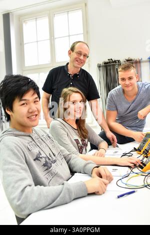 technical vocational training in industry: young apprentices and trainers in the classroom Stock Photo