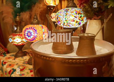 Closeup of Turkish Coffee Boilers Called Cezve Placed on the Hot Sand Stock Photo
