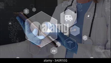 Image of medical icons over caucasian female doctor using tablet Stock Photo