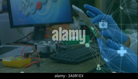 Image of network of connections with icons over caucasian scientist using tablet Stock Photo