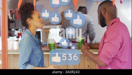 Social media likes image over people drinking green smoothies at counter Stock Photo