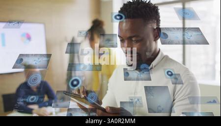 Image of digital screens with data over diverse colleagues talking and using tablet in office Stock Photo