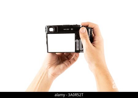 Male hands holding a photo camera with blanc screen isolated on white background Stock Photo