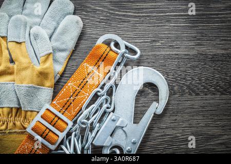 Construction gloves safety strap on wooden board Stock Photo