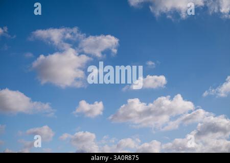 Blue 'Simpsons Sky' - clear blue sky with white fluffy clouds Stock Photo