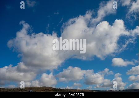 Blue 'Simpsons Sky' - clear blue sky with white fluffy clouds Stock Photo