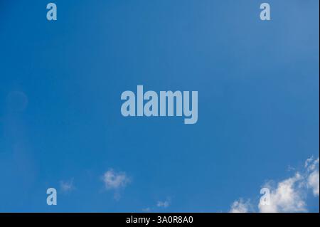 Blue 'Simpsons Sky' - clear blue sky with white fluffy clouds Stock Photo