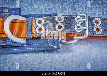 Construction body safety belt on scratched metallic background Stock Photo