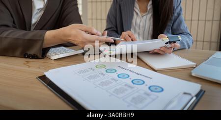 Project management discussion. Team members analyzing project details and collaborating effectively. Stock Photo