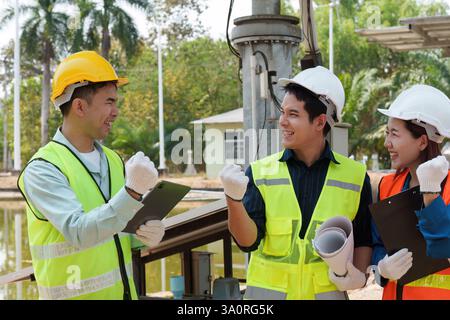 Team Collaboration. Diverse construction team celebrating after a successful project update, showcasing teamwork in sustainable initiatives. Stock Photo