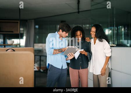 A diverse, talented team collaborates effectively in a bright office space during a business meeting Stock Photo