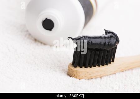 Toothbrush with black charcoal toothpaste Stock Photo