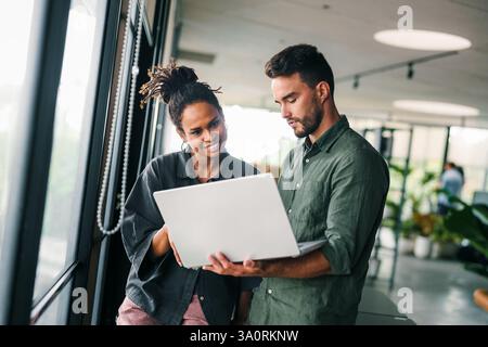 Mixed team of software engineers brainstorming ideas. Diverse app developers collaborating as group Stock Photo