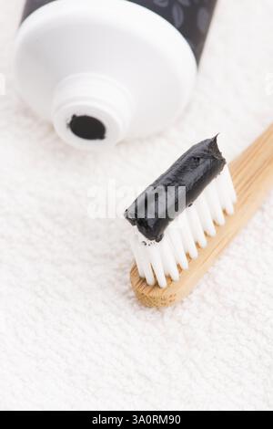 Toothbrush with black charcoal toothpaste Stock Photo