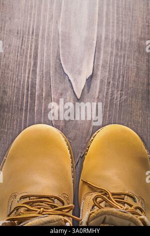 Close up view on working boots vintage wooden board with copyspace Stock Photo