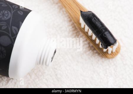Toothbrush with black charcoal toothpaste Stock Photo