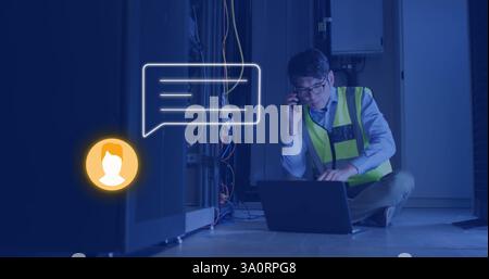 Image of media icon over asian male worker talking on smartphone in server room Stock Photo