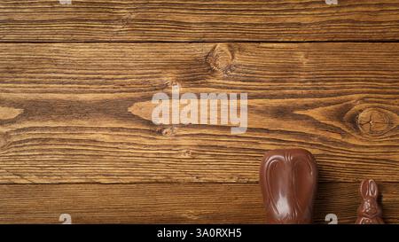 Wooden rustic background with chocolate easter bunnies and copy space for your advertising Stock Photo