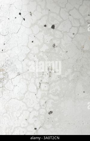 Fragment of a plastered wall with various surface defects that appeared over time vertical orientation Stock Photo