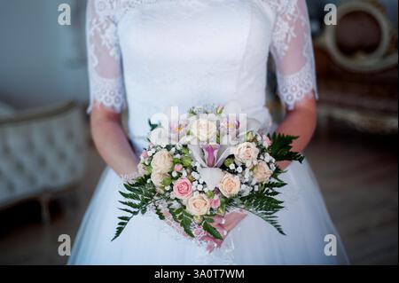 Beautiful bouquet of roses in the bride's hand Stock Photo