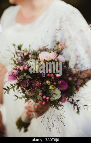 Beautiful bouquet of roses in the bride's hand Stock Photo