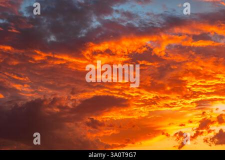 Dramatic orange clouds. Dramatic sunset background photo. Cloudscape with orange clouds. Stock Photo