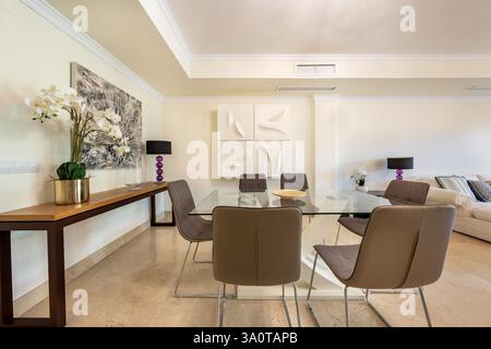 an image of a large glass dining table in luxurious mediterranean holiday home Stock Photo