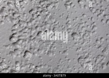 Close-up of light grey painted metal, highlighting surface textures with subtle variations in tone. Ideal for background and texture Stock Photo