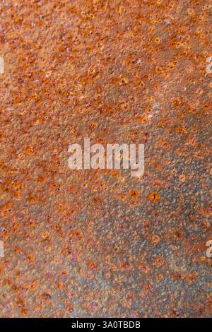 Close-up of rusted metal and weathered paint, featuring corrosion, peeling layers, and rough textures, perfect for background and texture Stock Photo