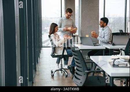 Having the business conversation. Men and woman are working in the office together. Stock Photo