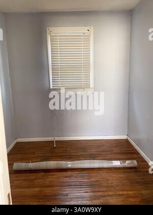 Small empty bed room with rolled up rug on floor . High quality photo Stock Photo