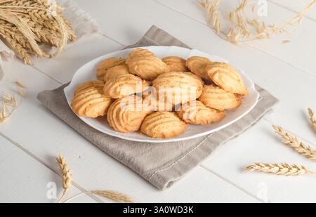 Shortbread cookies in a plate on a white wooden background. Stock Photo